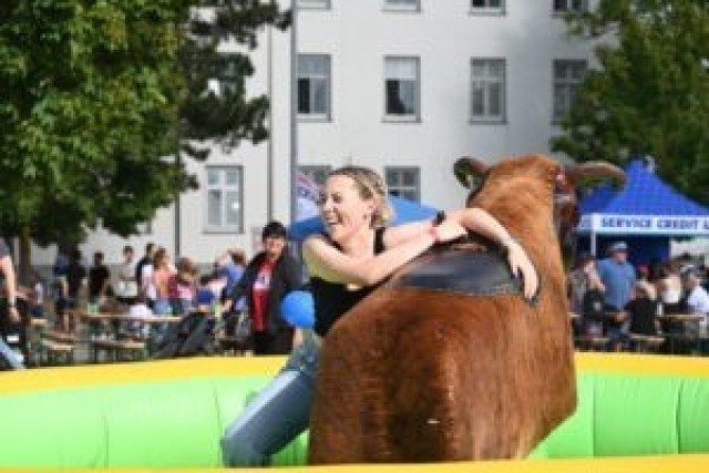 Riding the mechanical bull at US Army Garrison Stuttgart Independence Day event.