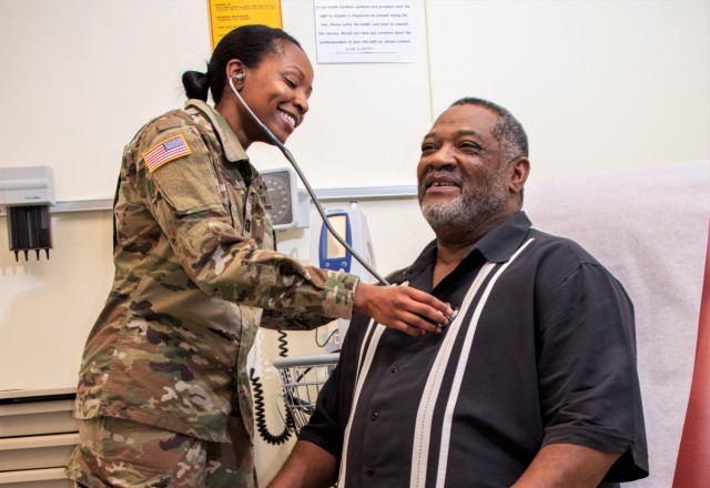 An Army physician looks after a patient. 