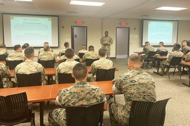 Col. Kevin Payne, 15th Military Police Brigade commander, briefs Army and Marine Corps corrections trainees with Fort Leonard Wood’s Company C, 701st Military Police Battalion, who were given the opportunity to tour some of the military’s...