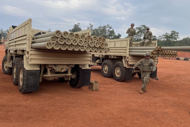 Army Sgt. Evelio Rosillo, a heavy equipment operator with the 555th Engineer Brigade, walks behind two light medium tactical vehicles full of 19-foot pipes during Exercise Talisman Sabre 23 in Weipa, Australia, July 18, 2023. Rosillo is part of the joint petroleum over-the-shore operation demonstrating critical logistical capabilities in the Indo-Pacific region.