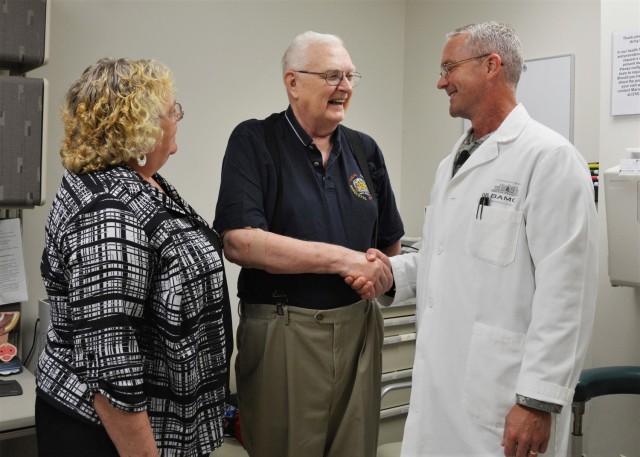 Army Col. (Dr.) Douglas Soderdahl, BAMC’s deputy commander for acute care, checks in with his longtime patient, Frank Samas, while Janet Schadee, urology and oncology clinical nurse, looks on in the Urology Department at San Antonio Military Medical Center, Aug. 11, 2015. Samas has rave reviews for his doctor. “He’s the best doctor here,” he said, “and that’s no lie.” 