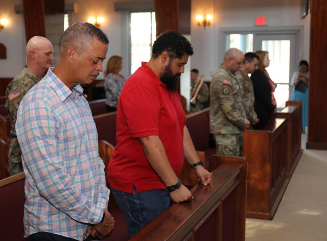 Attendees bow their heads in prayer during a ceremony celebrating the Camp Zama Chapel&#39;s 70 years of service and the U.S. Army Chaplain Corps&#39; 248-year anniversary at the chapel July 28, 2023. Built in 1953, the chapel was modeled after the Nasugbu Beach Chapel in Yokohama.