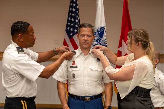Brig. Gen. Daryl O. Hood, Lt. Col. Nathan C. Cantwell and Romy Cantwell