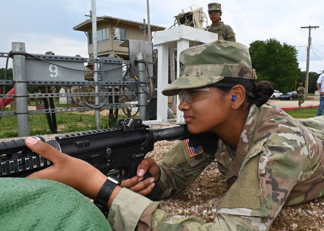 Pvt. Diana Acevedo, a trainee with Company B, 1st Battalion, 48th Infantry Regiment, prepares to confirm the aim on her M4 rifle at 175 meters Wednesday on Range 11, while her bunkmate and twin sister, Pvt. Andrea Acevedo, acts as the target...