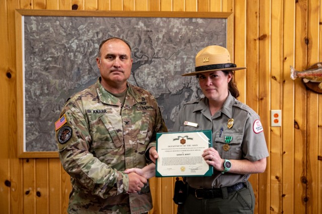 Little Rock District Commander, Col. Damon Knarr, presents Greers Ferry Lake Park Ranger Sarah Wyatt with a Life Saving Water Safety Award, an impact Civilian Service Commendation Medal, and District Coin of Excellence for her life saving efforts on Trouble Island July 4, 2023.