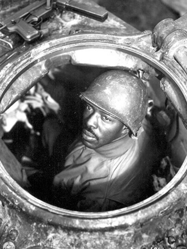 Gunner Cpl. Carlton Chapman poses in the hatch of his M4 Sherman tank near Nancy, France, Nov. 5, 1944.