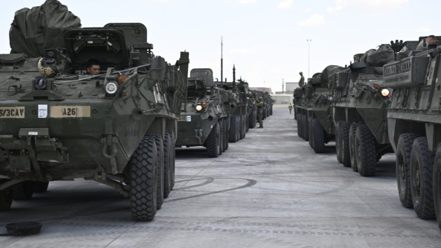 A row of M1126 Stryker Combat Vehicles sit in straight lines at the recently upgraded Deployment Ready Reaction Field before heading to the Rail Operations Center.