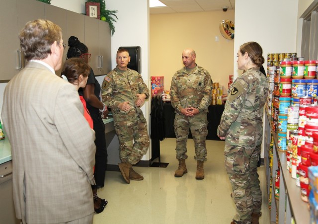 COL Joseph Messina, Fort Belvoir Garrison Commander, center, and Command Sgt. Maj. Garth Newell are briefed by Army Community Services director Tammye Braddy, left, about the newly opened ACS Food Pantry, offering walk-in service for families to avoid food insecurity. The pantry was opened while celebrating ACS&#39; 58th birthday. 