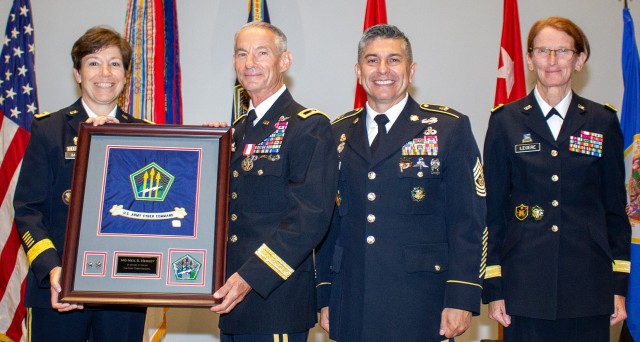 Maj. Gen. Neil S. Hersey, Deputy Commanding General-Operations, U.S. Army Cyber Command (ARCYBER)(second from left), accepts an ARCYBER flag presented to him by Lt. Gen. Maria B. Barrett, ARCYBER Commanding General (left) during Hersey's...