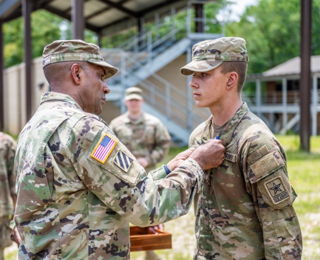 Gen. Gary M. Brito, Commanding General, United States Army Training and Doctrine Command presents the Soldier&#39;s Medal to Pfc. Matthew A. Cole