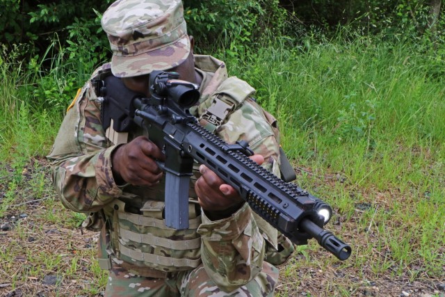 Army C5ISR Center enlisted adviser Sgt. Corey Burrell demonstrates a Small Tactical Universal Battery integrated into a Powered Weapon Demonstrator at Aberdeen Proving Ground, Maryland, on June 3, 2021.