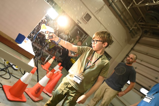Delta Junction student Peyton Wright shoots a water balloon as part of a high-speed optics experiment during a weeklong STEM camp hosted by U.S. Army Cold Regions Test Center Aug. 1-4. 