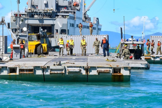 Distinguished visitors tour the Joint Logistics Over-the-Shore operation as a part of Talisman Sabre 23 in Bowen, Australia. JLOTS, enables the discharge of vehicles and equipment from sea to shore in austere environments, or when port facilities are damaged or unavailable.