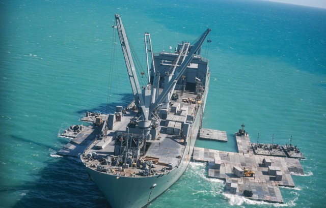 Army mariners assigned to the 368th Seaport Operations Company and 331st Transportation Company construct a causeway adjacent to the MV Maj. Bernard F. Fisher off the coast of Bowen, Australia, July 29, 2023. When complete, the causeway will form...