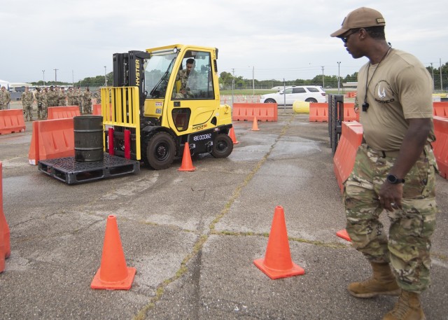 Air Force Senior Airman Caleb Schmelzle, with the Kansas Air National Guard’s 190th Logistics Readiness Squadron, in Topeka, maneuvers a forklift through an obstacle course Friday under the watchful eyes of the judges and fellow competitors during the Air Force Ground Transportation competitive rodeo event at a 368th Training Squadron training area near Bldg. 881.