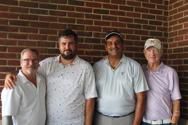 Garrison Scramble overall winners include, from left, John Cathey, his son Travis, Rudy Gil Sr. and Hap Terrell. They won with a 14-under 58.