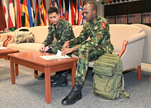 1st Lt. Chotinun Jantasee (left), a construction supervisor for the Royal Thai Army, and 1st Lt. T.A. Tahir, an engineer representative from the Nigerian Army, discuss their displays Wednesday in the International Military Student Office lounge for the Know Your World event, scheduled for 6 to 8 p.m. Aug. 25 at Nutter Field House. 