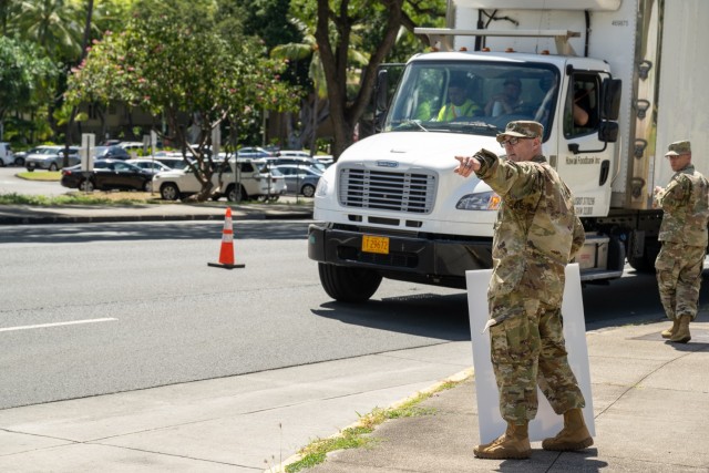 A Soldier directs a truck for donations operations in support of those affected by the Maui wildfires. 