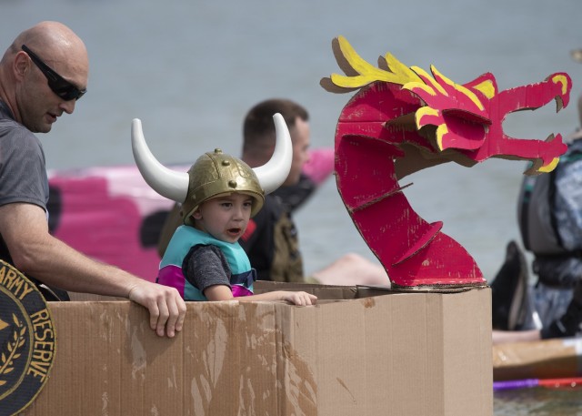 Three-year-old Carlyle Hatch, and his father, Dennis, get ready to take to the water in this year’s Cardboard Boat Race Saturday at Training Area 250. The Hatch family, along with teammate Byron Steele, competed as “Compos 2&3,” and ended up taking home a “Titanic Award,” for most-epic sinking.  
