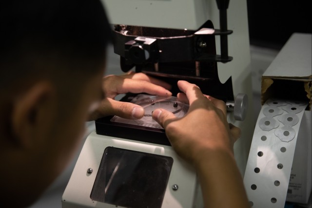Optical laboratory specialist fabricates prescription glasses