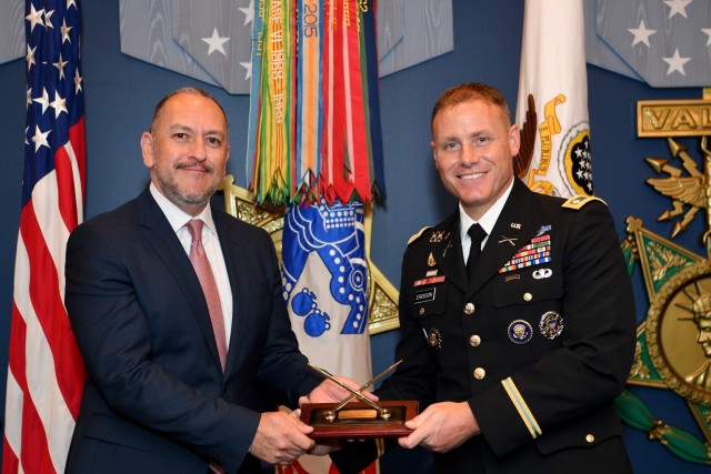 The Under Secretary of the Army, the Honorable Gabe Camarillo presents the 61st Annual Pace award to Lt. Col. Neal R. Erickson, Analysis Support Branch Chief, Warfighting Analysis Division, Force Development Directorate, Deputy Chief of Staff, G-8, during a ceremony at the Pentagon in the Hall of Heroes, Arlington, Va., August 10, 2023.