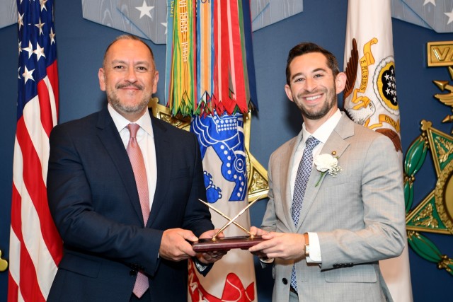 The Under Secretary of the Army, the Honorable Gabe Camarillo presents the 61st Annual Pace award to Mr. Michael C. Levinson, Chief, Modern Delivery, Financial Operations and Information, Office of the Assistant Secretary of the Army for Financial Management and Comptroller, during a ceremony at the Pentagon in the Hall of Heroes, Arlington, Va., August 10, 2023. 