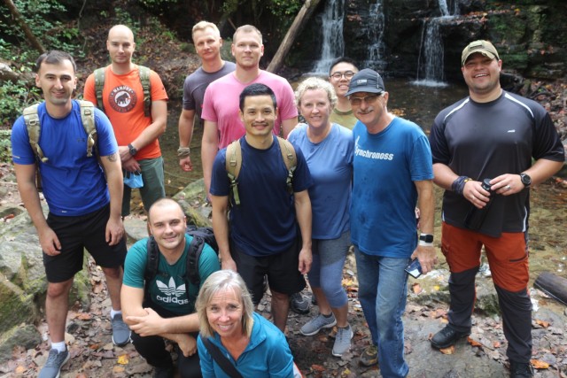 Community Ambassadors, David and Sharon Barkman (second and fourth from right), take a break from hiking in Franklin Delano Roosevelt State Park and pose for a photo with a group of international military students assigned to the Maneuver Center of Excellence Oct. 24, 2020, at Pine Mountain, Ga. 