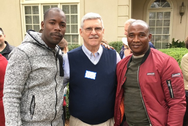 Ron Collins, center, a community ambassador, welcomes International Military Students to his home for a lunch Feb. 10, 2019. Community ambassadors help international military students assigned to the Maneuver Center of Excellence and Fort Moore, Ga., experience American culture and fellowship during their time in the U.S.