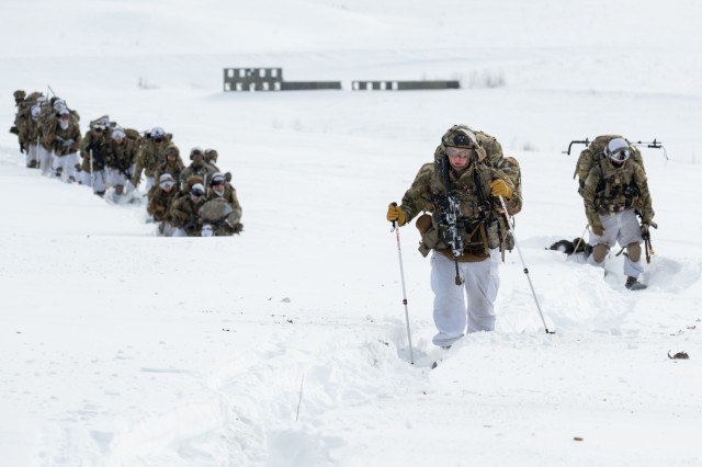 U.S. Army paratroopers assigned to the 3rd Battalion, 509th Parachute Infantry Regiment, 2nd Infantry Brigade Combat Team (Airborne), 11th Airborne Division, move across a snow-filled landing zone during Joint Pacific Multinational Readiness Center-Alaska 23-02 at Yukon Training Area, Ft. Wainwright, Alaska, March 28, 2023. With more than 8,000 participants and observers from 12 different countries, JPMRC-AK 23-02’s multinational environment helps increase Arctic proficiency throughout the Army and the joint force, in support of the nation’s, and the Army’s Arctic strategy. 