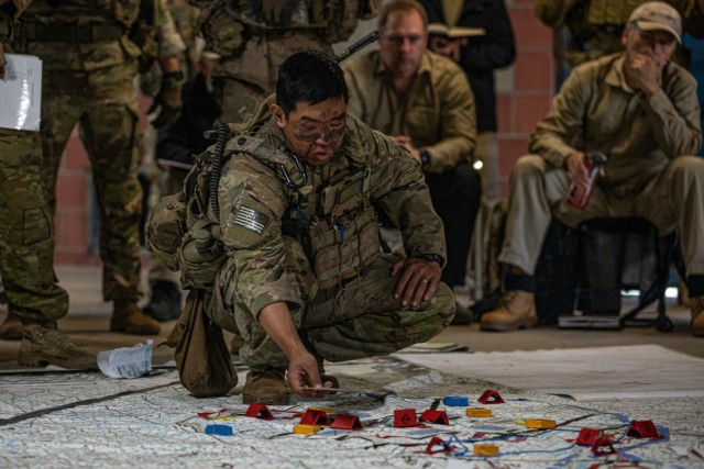 U.S. Army Lt. Col. Patrick Yun briefs scheme of maneuver while participating in a Rehearsal of Concept drill with multilateral military partners from Germany and the USA during Exercise Talisman Sabre 2023 at Townsville Field Training Area, Queensland.