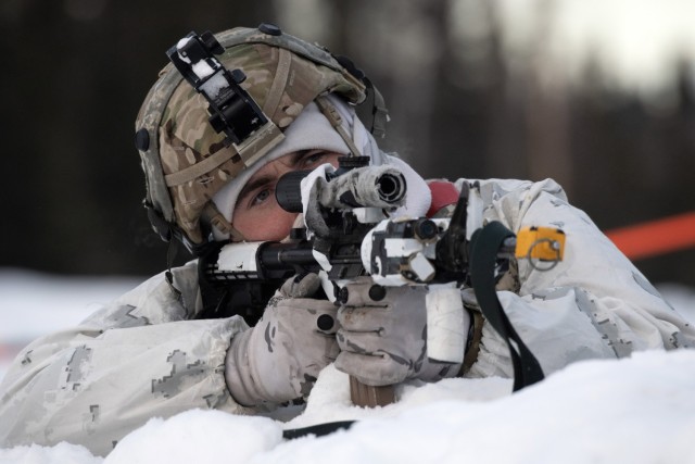 A U.S. Army infantryman with Bayonet Company, 1st Battalion, 5th Infantry Regiment, 1st Brigade Combat Team, 11th Infantry Division, sights in on an enemy target with his M4 carbine while acting as opposition forces for Joint Pacific Multinational Readiness Center-Alaska 23-02 at Yukon Training Area, Fort Wainwright, Alaska, April 1, 2023. JPMRC-AK 23-02 is a display of the 11th Airborne Division’s ability to survive and thrive in the Arctic, and its soldiers’ ability to fight and win our nation’s wars anywhere. 