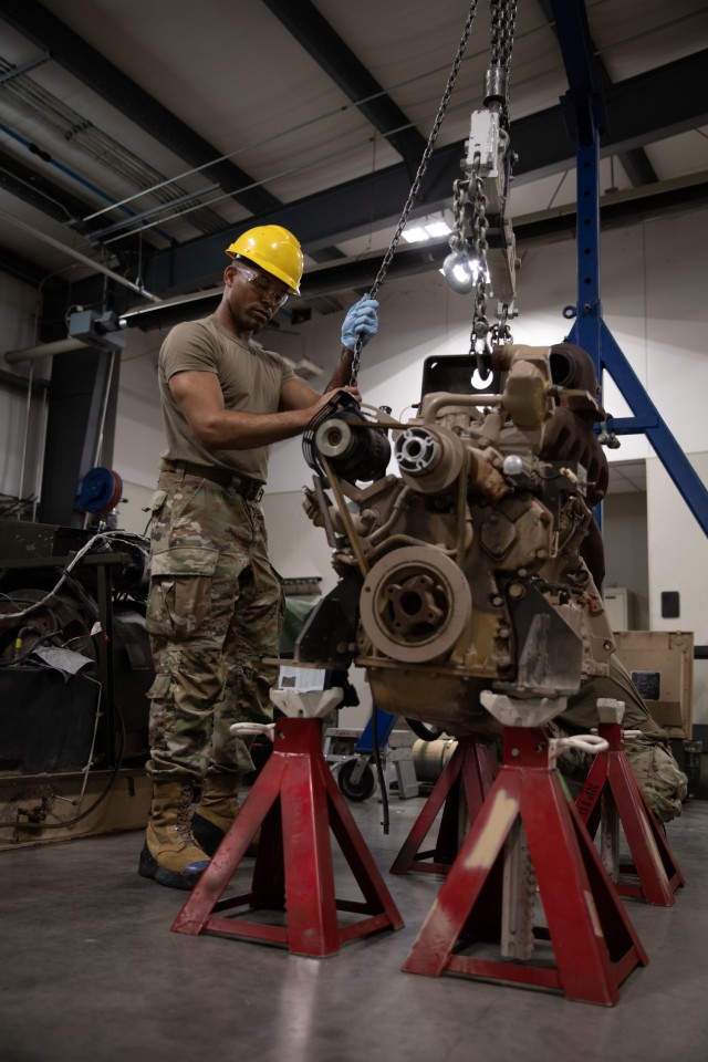 U.S. Army Pfc. Rashad Johnson, a power generator specialist with the 277th Maintenance Company, 110th Combat Sustainment Support Battalion, 78th Troop Command, Georgia Army National Guard, lowers a diesel engine during a training rotation at Camp...