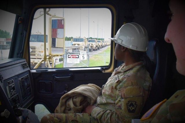 Army Spc. Awuku Godfred, a heavy vehicle mechanic with the 131st Transportation Company, peers out the window of a M915 Line Haul Tractor (LHT), awaiting the signal to initiate the convoy at McAlester Army Ammunition Plant during Operation Patriot...