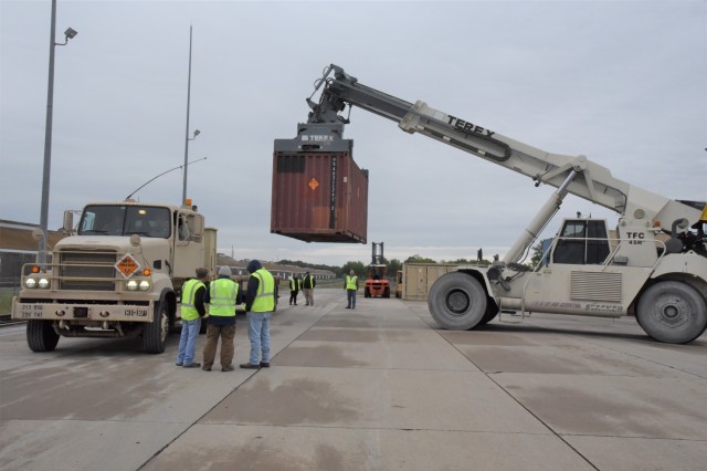 Members of Quality Assurance Specialist-Ammunition Surveillance (QASAS) Fellows Group 118, assists with the loading of ...