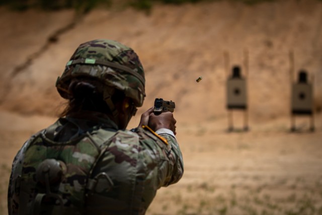 A Soldier assigned to 3rd Special Forces Group (Airborne) fires her pistol during best squad competition at Camp Mackall, NC, on June 27, 2022. The competition tests the squad&#39;s basic soldier skills, tactical and technical proficiency, and team cohesion in physical fitness, land navigation, rifle and pistol marksmanship and tactical operations.