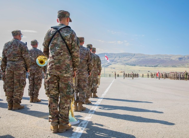 Members of the Military Orchestra of the Defence Forces, Georgian National Guard, stand at attention during the opening ceremonies of exercise Agile Spirit at Krtsanisi Training Area, Georgia, on August 21, 2023. The band was activated in 1991, and its main role is as ceremonial accompaniment for various official functions and activities throughout the country. 