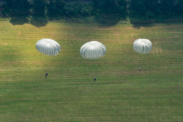 Paratroopers steer towards the drop zone after jumping during the annual Leapfest International Parachute Competition and training event hosted by the Rhode Island National Guard on August 5, 2023.