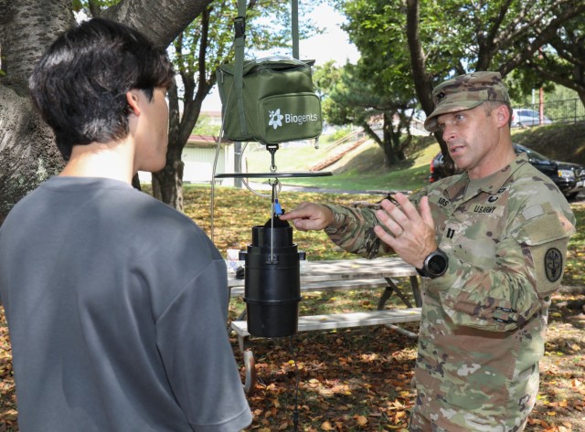Capt. John Eads, chief of the Entomology Laboratory at Public Health Command–Pacific in Japan, speaks to Ryo Shibanuma, an intern, about a vector trap during a knowledge-sharing event at Camp Zama, Japan, Aug. 21, 2023. PHC-P experts showed a handful of professors from the National Defense Medical College and interns in U.S. Army Garrison Japan’s summer internship program how to perform real-time pathogen analysis and discovery in an austere setting. 