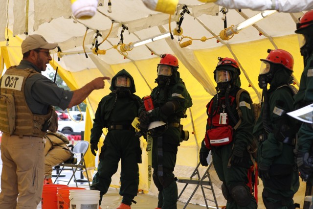 A search and extraction team conducts a debriefing with an instructor following their casualty search. Approximately 180 Soldiers and Airmen from Maine, Rhode Island, and New Hampshire came together at Joint Base Cap Cod, Massachusetts, Aug. 12-18, 2023, for an external evaluation of the New England CERFP, a regional National Guard response team that assists first responders during large-scale emergencies. (Maj. Carl Lamb)
