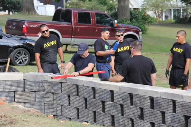 Ozark Mayor Mark Blankenship helps Warrant Officer Candidates and Better Opportunities for Single Soldiers volunteers build a retaining wall at the Holman House in Ozark, Ala. on August 26, 2023.