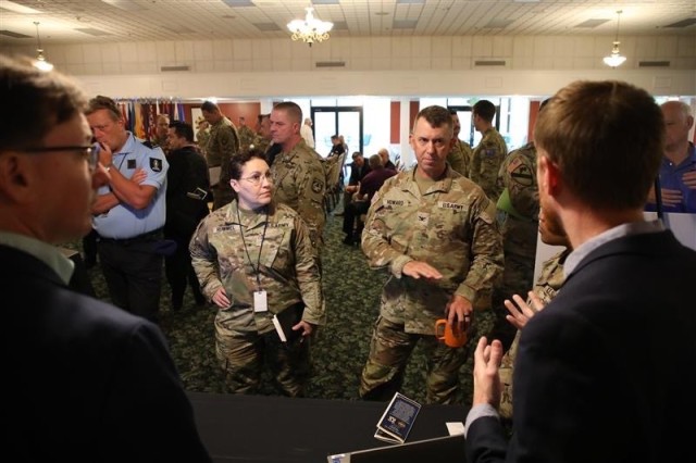 Brig. Gen. Christine Rummel, the Mobilization Assistant to the Commanding General of Army Cyber Command (left), and Col. Paul D. Howard, commandant of the U.S. Army Signal School and the Army&#39;s 42nd Chief of Signal (right) hear from vendors during Cyber Quest 23. 