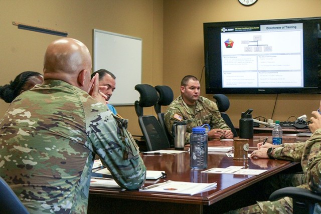 Sgt. Maj. Robert Flynn visits with leadership from the Directorate of Training on Aug. 21, 2023, at Fort Leavenworth, Kan. 