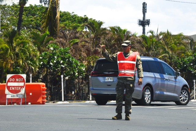 Spc. Kaimana McBrayer, a fire control specialist with the Hawaii Army National Guard’s 1st Battalion, 487th Field Artillery Regiment, pops a “Shaka” hand gesture while directing traffic as part of the National Guard’s response to the deadly Maui wildfires in Lahaina, Hawaii, Aug 25, 2023. The Defense Department and the U.S. Coast Guard are supporting the FEMA-led response to the deadliest wildfire in Hawaii’s history.

