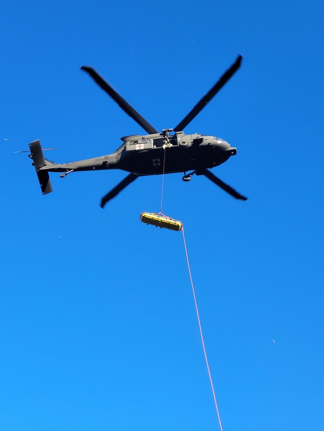 A Wyoming Army National Guard helicopter crew, working with local agencies, executes a daring aerial evacuation during a challenging 24-hour rescue mission of two climbers in Box Elder Canyon, Converse County, on Aug. 15, 2023.
