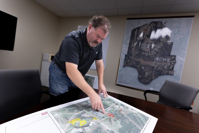 Clint Howard looks over some maps in the Directorate of Public Works environmental office.