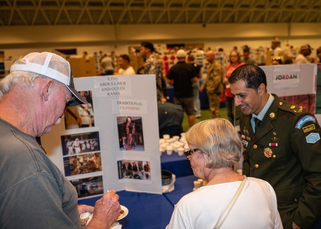 Maj. Mohammad Elturshan, an international student from Jordan, shares traditional food with visitors to his booth at the 21st Know Your World event, hosted by the International Military Student Office Friday at Nutter Field House.