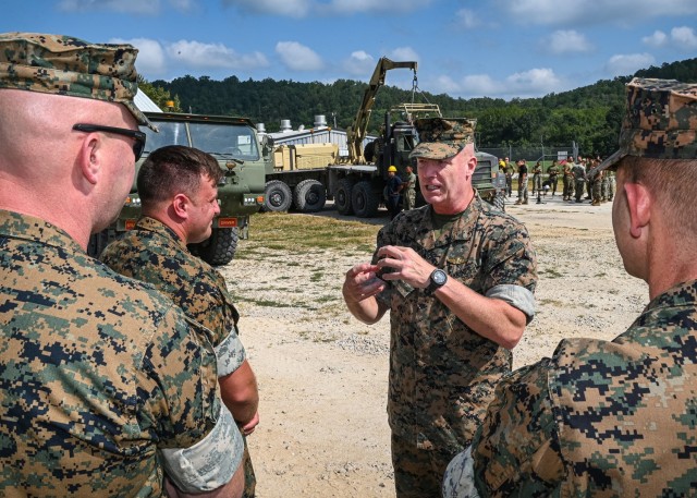 Marine Brig. Gen. Michael McWilliams, 2nd Marine Logistics Group commanding general, talks with Marine Corps Detachment Fort Leonard Wood leadership Wednesday while visiting Training Area 61, where Motor Transport Instruction Company instructors teach the Vehicle Recovery Course. 