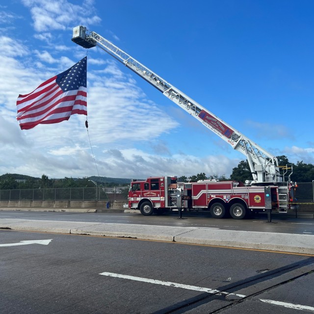 Picatinny Arsenal and Fire Emergency Services positioned Fire Truck (Ladder 17) over the Mount Hope overpass in Rockaway, New Jersey on August 30 to display the U.S. flag as the Warriors’ Watch Riders in conjunction with the New Jersey State...