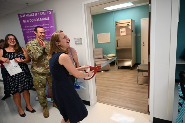 Amy Yeager, district director, Bell County Public Health, Maj. Matthew Nestander, Chief of Inpatient Pediatrics and NICU Medical Director, Carl R. Darnall Army Medical Center, Fort Cavazos, and a host of infants and mothers stand by as Nicole...