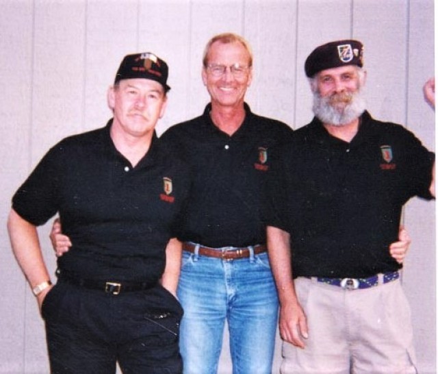 Dave Hill (left), Larry Taylor (center), and Paul Elsner, patrol team lead, pose for a photo at annual unit reunion in 1999. This was the first time Hill and Elsner met Taylor since he rescued them in 1968.